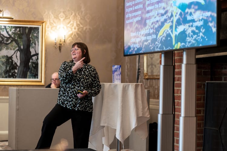 Janine presenting on stage.